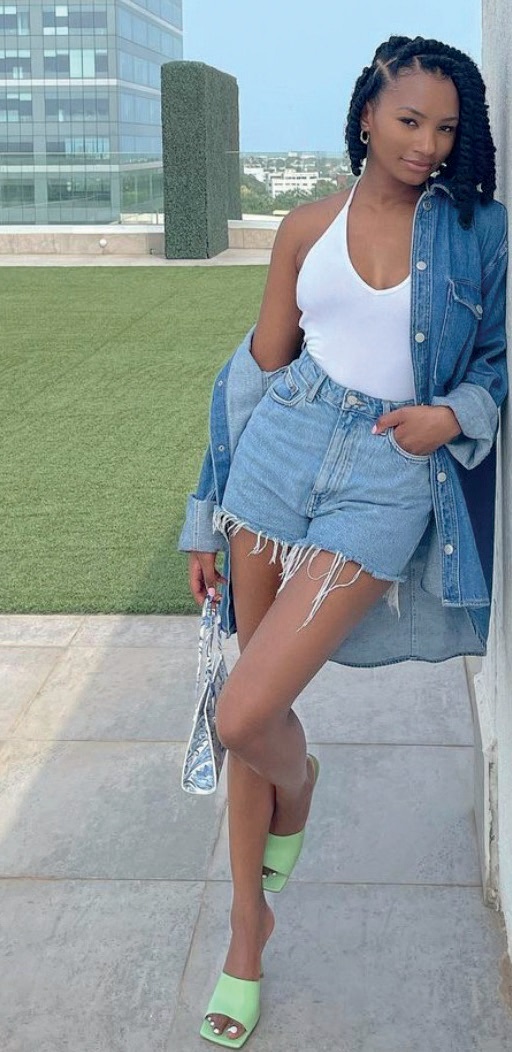 An oversized denim jacket paired with distressed jean shorts