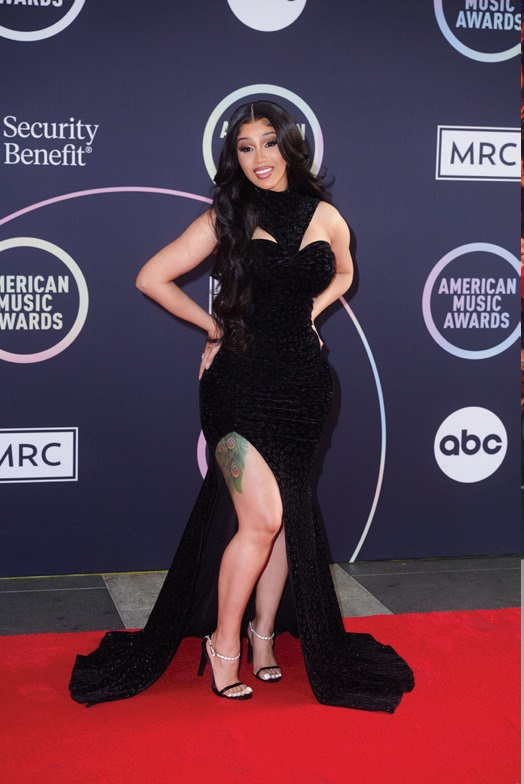 Cardi B arrived in a black gown with a sequin leopard-print pattern
