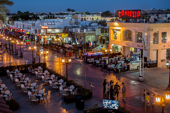 SHARM EL SHEIKH, EGYPT - APRIL 01: Tourists stand outside a restaurant on a shopping street in Naama Bay on April 1, 2016 in Sharm El Sheikh, Egypt. Prior to the Arab Spring in 2011 some 15million tourists would visit Egypt each year. The resort town of Sharm El Sheikh was built around tourism however tourist numbers have plummeted after recent terrorist attacks with flights from major UK carriers being suspended and foreign offices around the world warning citizens of the 'High threat from terrorism' Sharm El Sheikh is almost a ghost town, with many resorts being abandoned and business forced to close. (Photo by Chris McGrath/Getty Images)